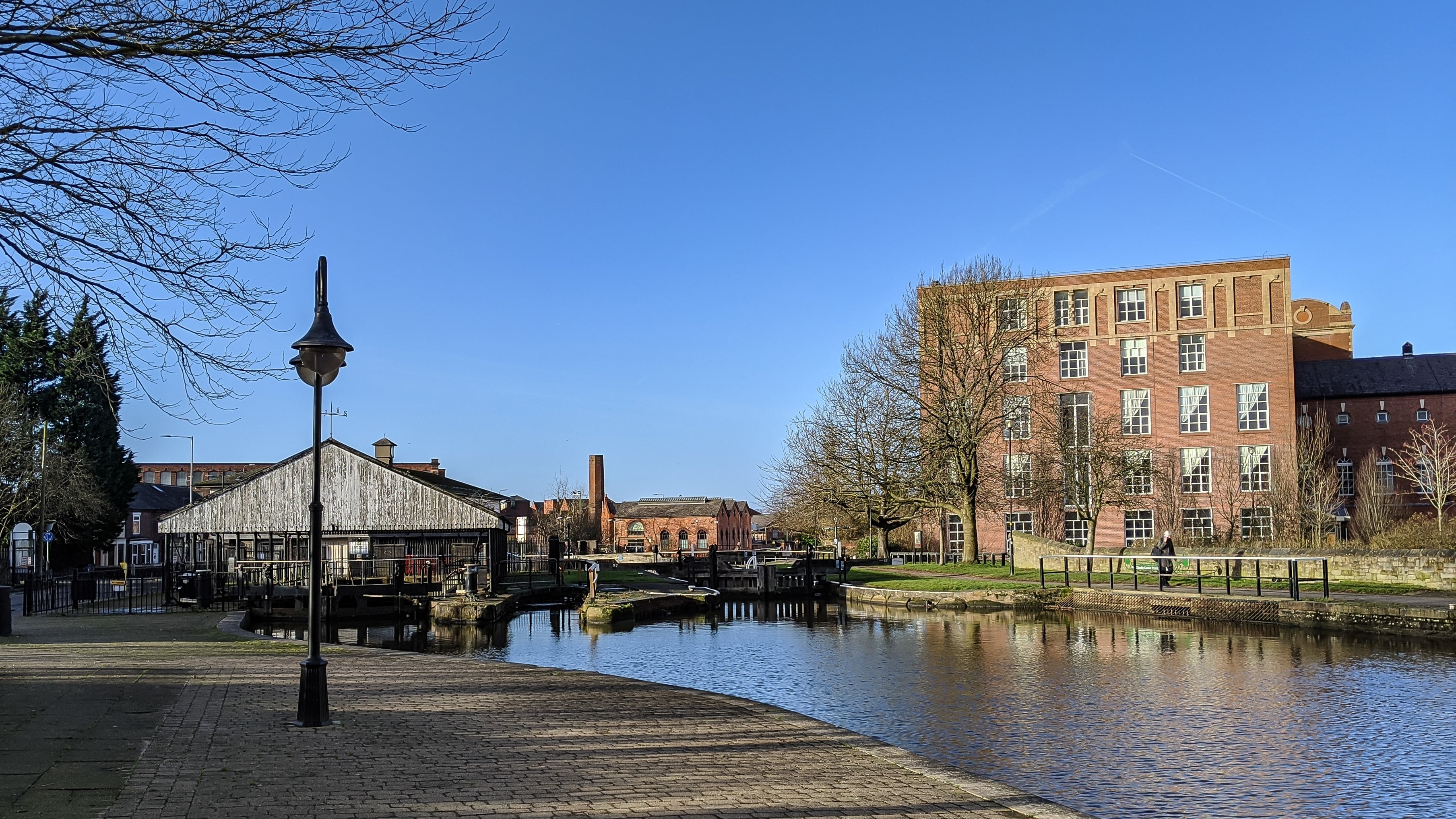 Una foto de un pequeño pueblo con un río en un hermoso día soleado.