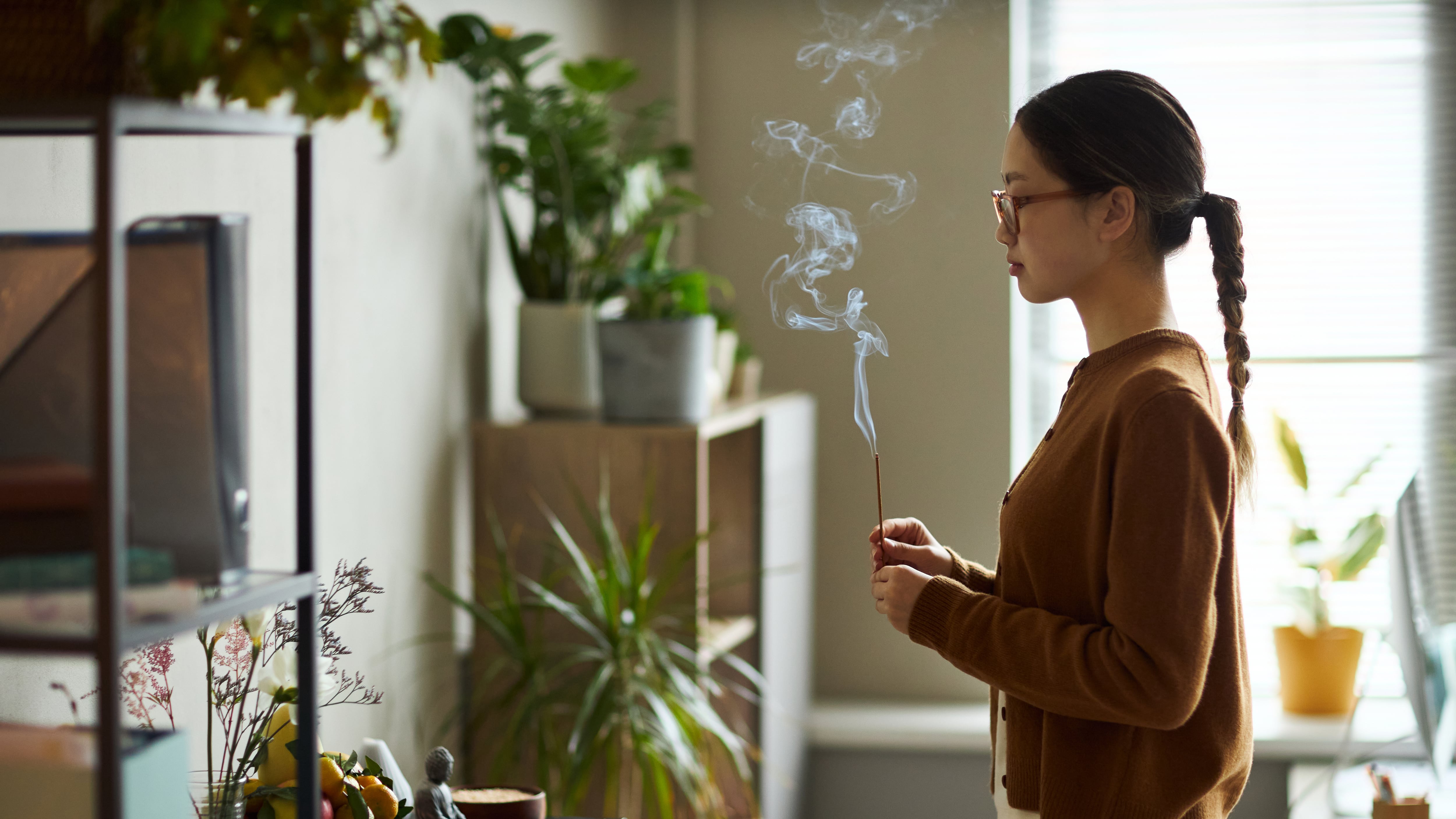 Young Asian Woman Standing Indoors Holding Incense S