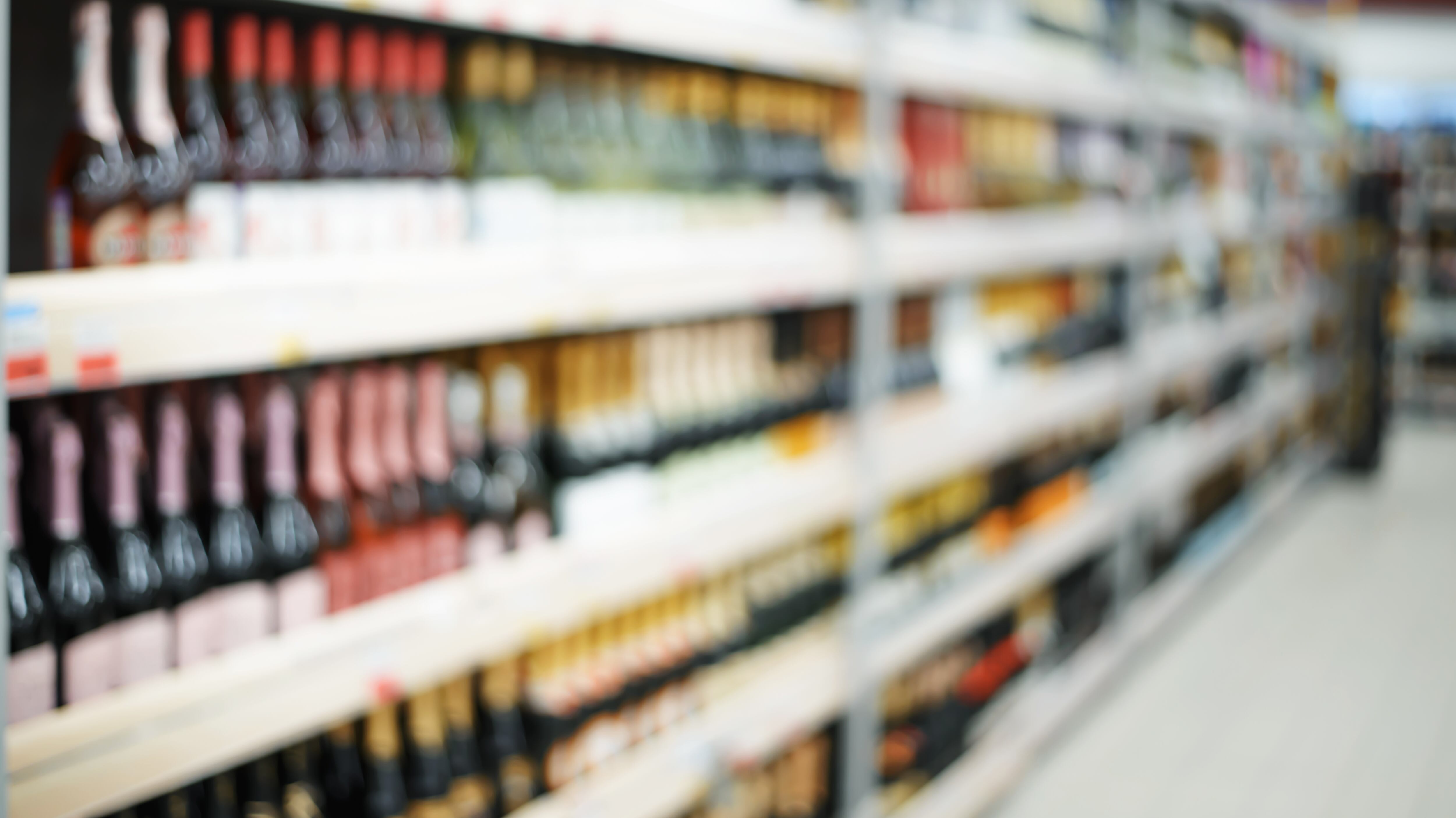 Sección de bebidas alcohólicas desenfocada en un supermercado
