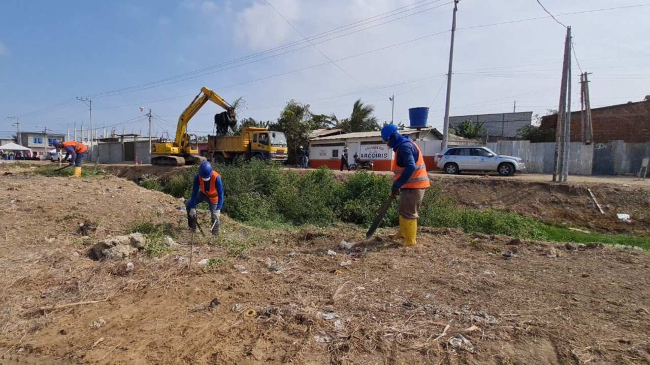 Personal de EMAPAG-EP remueve los escombros y basura del canal de la cooperativa 25 de Julio.